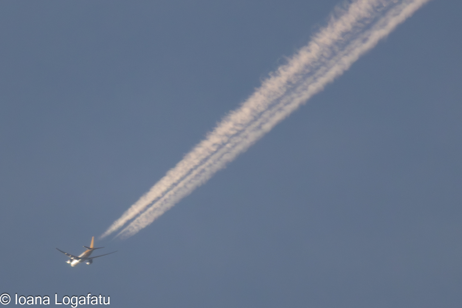 Clouds weave paths as airplane glides across sky